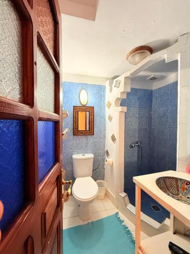 a bathroom with a toilet and a sink at Dar Sababa in Chefchaouen