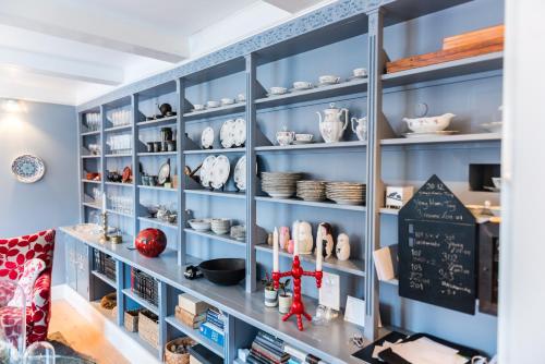 a shelf filled with lots of dishes and bowls at Reykjavík Treasure B&B in Reykjavík