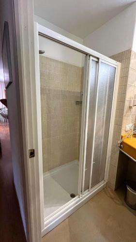 a shower with a glass door in a bathroom at Casa la Paloma in Es Caló