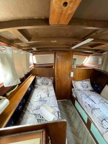 an empty room with two beds in a boat at Original Friendly Boat in Sant Pau dʼOrdal
