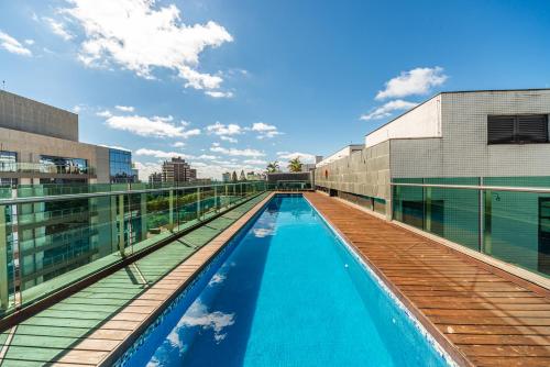 a swimming pool on the roof of a building at Hotel Laghetto Moinhos in Porto Alegre
