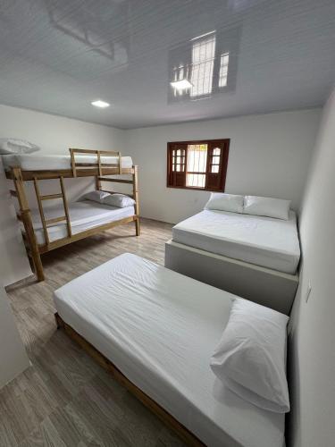 a room with two beds and a bunk bed at Sofi House Zap in Zapatoca