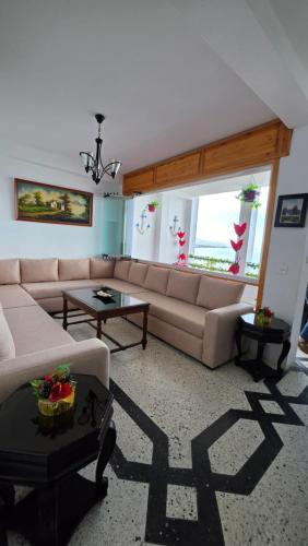 a living room with a couch and a table at Star beach in M'diq