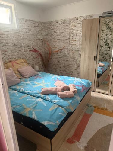 a bed with towels on it in a room at KiDo Apartman in Balatonberény