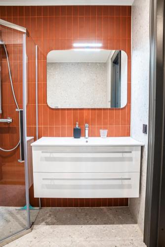 a bathroom with a white sink and a mirror at Livonia Central Apartments in Valga