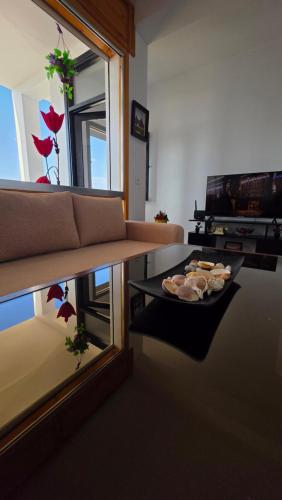 a living room with a couch and a table and a mirror at Star beach in M'diq