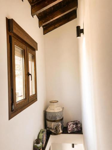 a room with a window and a barrel on a shelf at Ca el retriñon in Felechosa