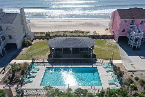 an aerial view of a swimming pool and the beach at Dune Our Thing in Kure Beach