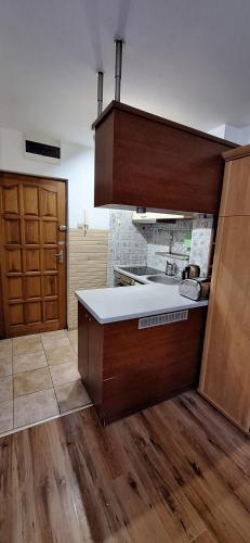a kitchen with a sink and a counter top at Przy rynku in Olecko