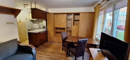 a kitchen and dining room with a table and chairs at Przy rynku in Olecko