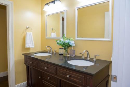 a bathroom with two sinks and a mirror at Ground Floor, 3BR, Free Parking, Near Refinery -E- in Moss Point