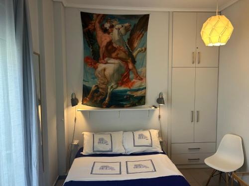 a bedroom with a bed with a painting on the wall at Royal Zea Suite 3 in Piraeus