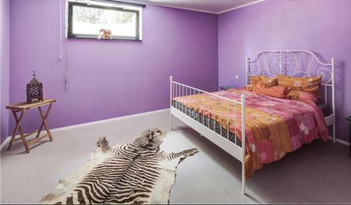 a bedroom with a bed and two zebras laying on the floor at Immas Welt in Utting
