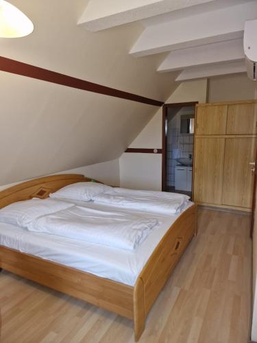 a bedroom with a large bed with a wooden frame at La Fontana in Langelsheim