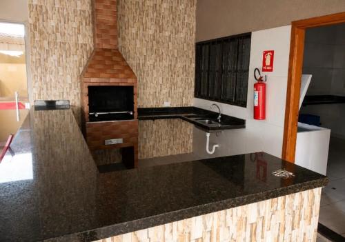 a kitchen with a sink and a fire hydrant at Recanto sonho meu in Trindade