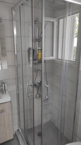 a shower with a glass door in a bathroom at Royal Zea Suite 3 in Piraeus