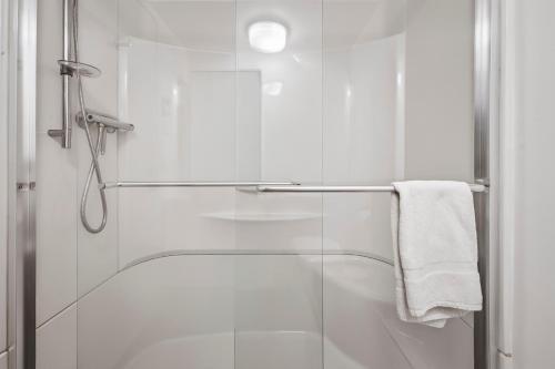 a shower with a glass door and a towel at Unit 31 - 5 bedrooms, 8 people in Beaupré