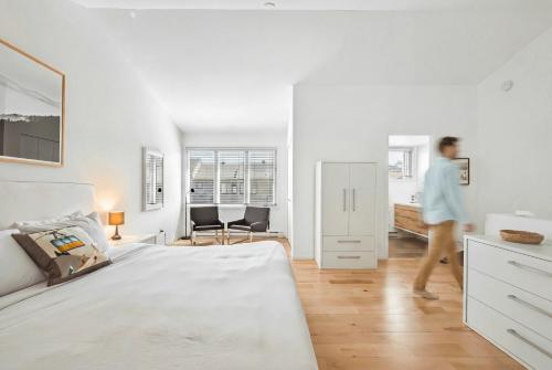 a person walking through a bedroom with a bed at Unit 31 - 5 bedrooms, 8 people in Beaupré