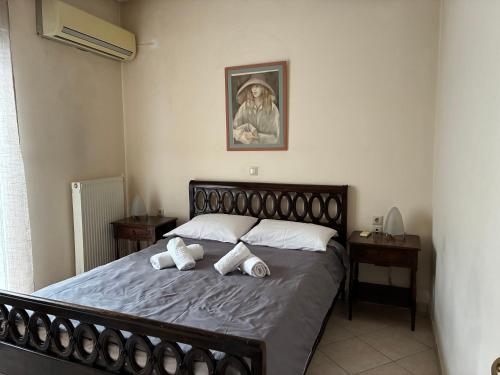 a bedroom with a bed with two pillows on it at Basis Apartment in Karpenisi