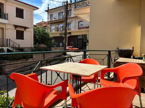 a table and chairs on the balcony of a building at Basis Apartment in Karpenisi