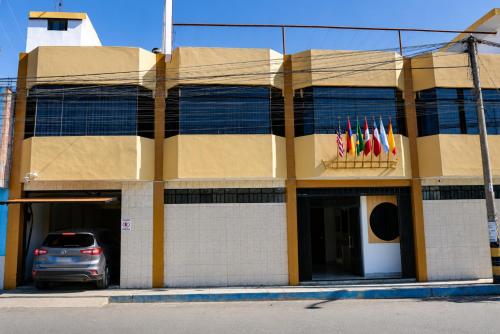 a building with a car parked in front of it at Villa Fernanda Hotel in Tacna