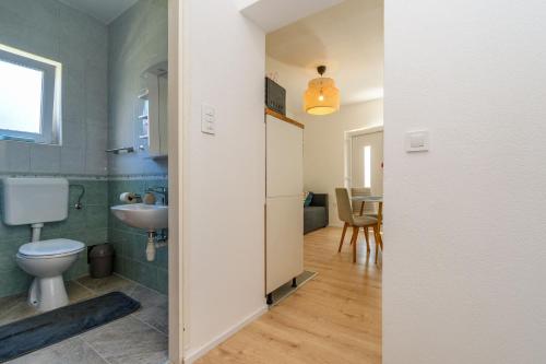 a bathroom with a toilet and a sink at Apartments Ian in Lopar