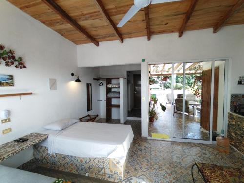 a bedroom with a bed and a sliding glass door at Roof Garden 3 in Coatepec