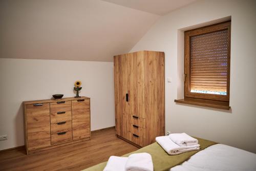 a bedroom with a bed and a wooden cabinet at Nad Drwęcą in Mszano