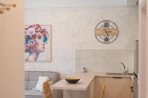 a kitchen with a table and a sink and a counter top at Socratous Apartments in Mytilene