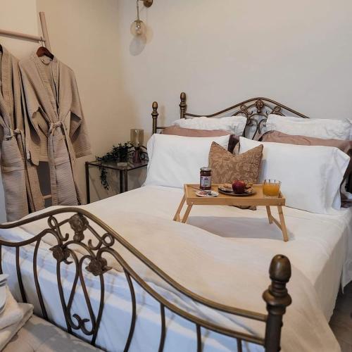 a bedroom with a bed with a tray of fruit on it at City Center Suites in Karpathos