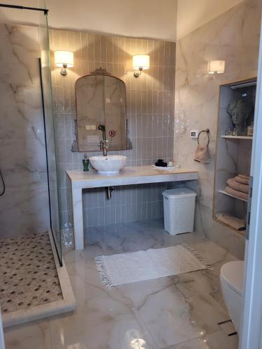 a bathroom with a sink and a mirror at City Center Suites in Karpathos