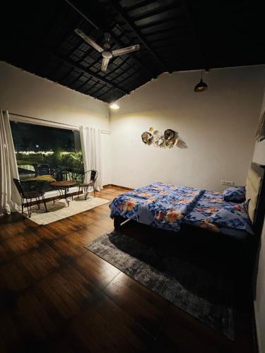 a bedroom with a bed and a table in it at The cosmos farm in Gurgaon