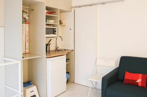 a living room with a couch and a kitchen at Souplex - 4P - Batignolles in Paris