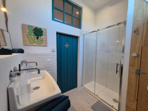 a bathroom with a sink and a shower at La Granch' - Maison d'hôtes in Harcourt