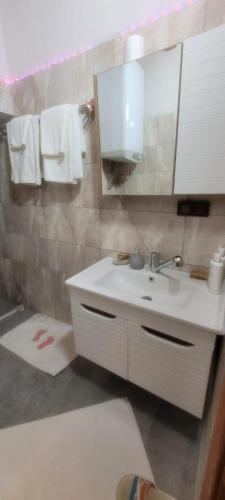 a bathroom with a sink and a mirror at Hacel's Stairs in Ordu