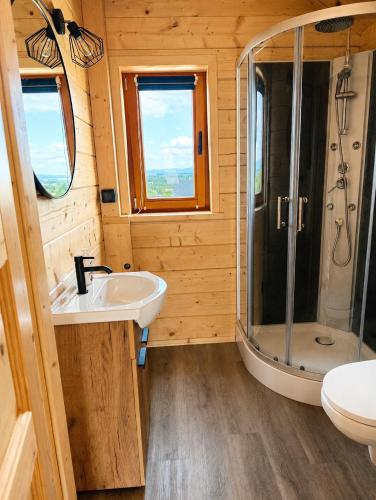 a bathroom with a sink and a shower at Podhalańskie Chaty in Rokiciny Podhalanskie
