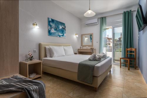 a bedroom with a large bed and a window at ΤΗΕRAMVOS in Pefkochori