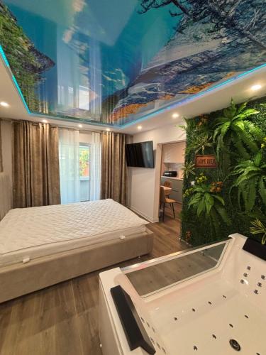 a bedroom with a bed and an aquarium on the ceiling at D&D Studio in Petrila