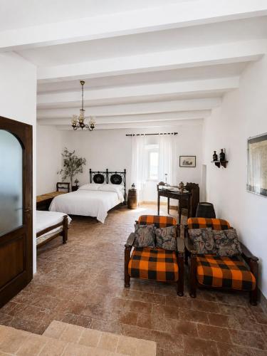 a large bedroom with two beds and a couch at Castello di Mongiovino Vecchio "La Casa in Piazza" in Panicale