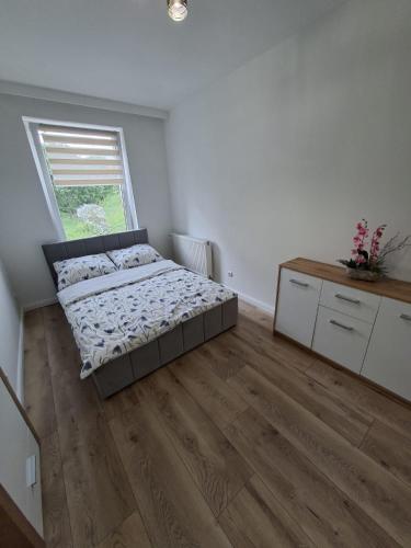 a bedroom with a bed and a window at NOVA Apartament Podgórze in Wałbrzych