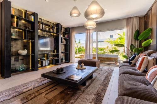 a living room with a couch and a coffee table at Villa Maya Rooftop beach access heated pool in Le Grau-dʼAgde