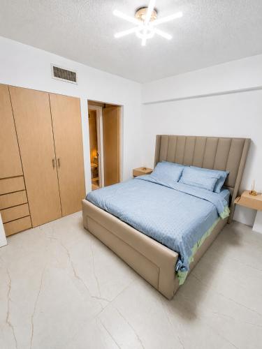 a bedroom with a bed with a blue comforter at Apartamento vacacional pampatar in Pampatar