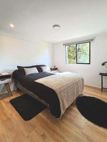 a bedroom with a large bed and a window at Garden House Las Condes in Santiago