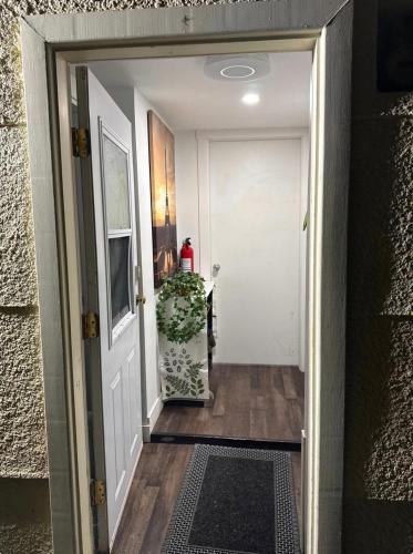 a hallway leading to a white door with a rug at Victoria BNB in Victoria