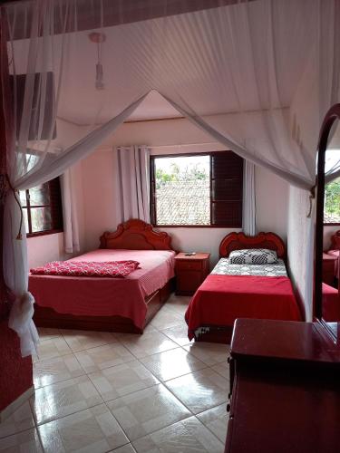 a bedroom with two beds and a window at Hospedagem Serra da Lua in Alter do Chao