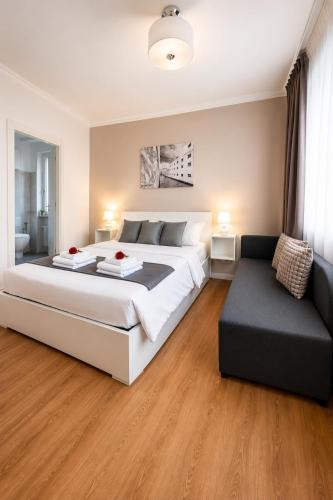 a bedroom with a large bed and a couch at Corso Venezia in Mestre