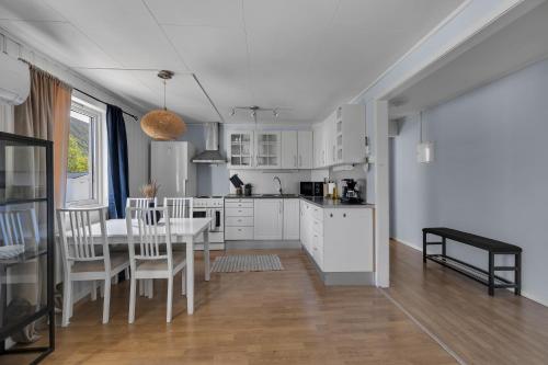 a kitchen and dining room with a table and chairs at Apartment in Tromsdalen in Tromsø