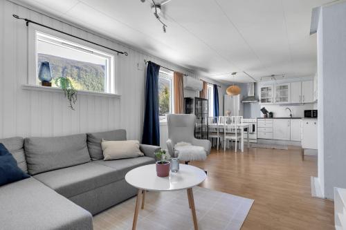 a living room with a couch and a table at Apartment in Tromsdalen in Tromsø