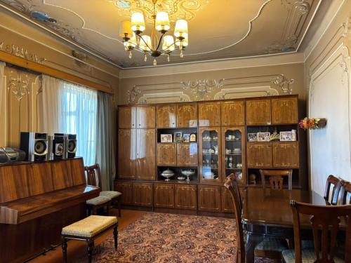 a dining room with a table and a chandelier at Sargis guest house in Ushi