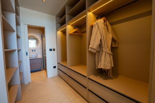 a walk in closet with drawers and cabinets at Apartments Villa Medic in Brela
